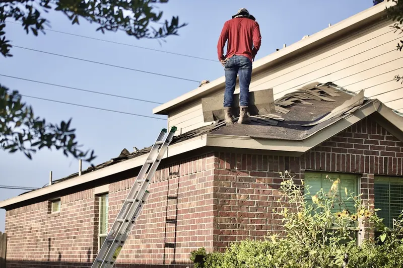 Professional roofer working on a residential roof in Young America